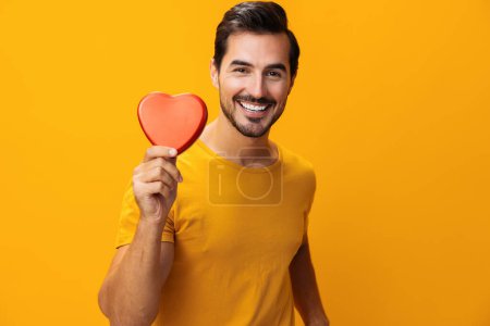 Photo for Man hand shape valentine smiling romance studio heart background concept romantic portrait red yellow love symbol gift box happy - Royalty Free Image