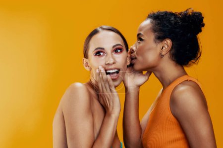 Photo for Two woman race bodycare beautiful portrait healthy colorful together african studio attractive yellow beauty face shine model american happy skin mixed girl make-up - Royalty Free Image