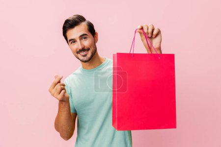 Photo for Fashion man shop holiday buy discount surprise store package shopper bag pink client lifestyle sale happy purchase gift isolated present - Royalty Free Image