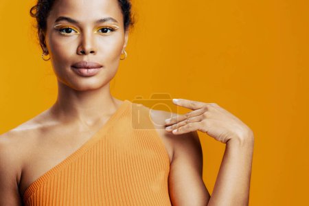Téléchargez les photos : Cosmétique femme modèle portrait créatif peau jaune coloré beauté noir visage copie style africain espace belle cosmétologie studio maquillage sourire mode - en image libre de droit