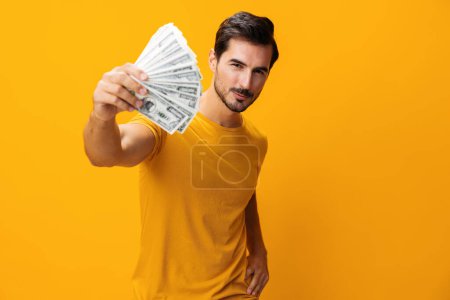 Photo for Man casino dollar success background smiling finance shopping business credit hand yellow money studio excited rich surprised cash happy currency - Royalty Free Image