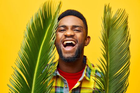 Photo for Stylish man yellow palm tree african african studio happy leisure black american ethnicity tropical handsome freelancer fun skin style smiling copyspace palm fashion - Royalty Free Image