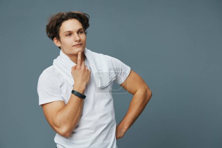 Photo for Man white isolated attractive lifestyle shot muscle training sport background fit t-shirt body grey athletic caucasian towel young exercise person muscular torso - Royalty Free Image