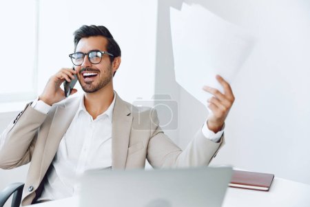 Man businessman male entrepreneur mobile modern smile office winner laptop computer sitting portrait conversation document smart call talk wireless manager lifestyle phone