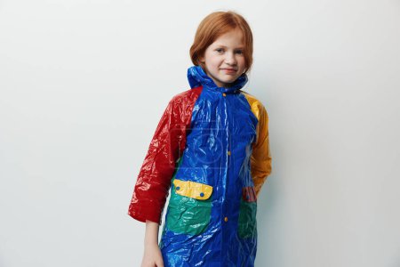 Photo for Blue person female studio children human caucasian portrait little rain cute childhood hair background raincoat lifestyle girl clothing bright young fashion kid beauty - Royalty Free Image