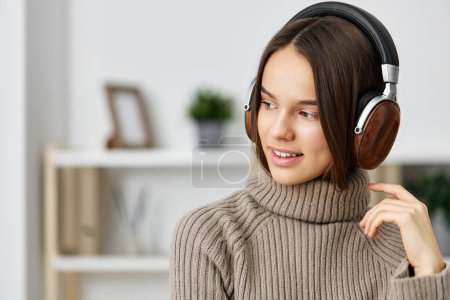 Photo for Woman person music leisure girl student lifestyle smartphone phone caucasian melody indoor young apartment home headphones brunette house happy online earphones - Royalty Free Image