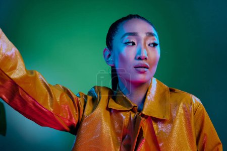 Photo for Woman green face beauty vogue trendy glowing elegant asian yellow female light vivid skin disco fashion multicolor art colorful neon stylish lady model bright - Royalty Free Image