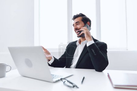 Photo for Man businessman sitting mobile communication technology office cellphone phone adult laptop talk occupation business computer portrait male desk manager - Royalty Free Image