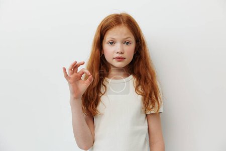 Photo for Cute yellow little portrait caucasian children ginger white studio gesture face girl person beautiful expression young female isolated redhead background - Royalty Free Image
