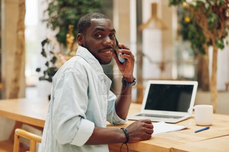 Photo for Business man adult laptop professional happy technology lifestyle businessman smile sitting modern office phone portrait looking male desk working person young computer black - Royalty Free Image