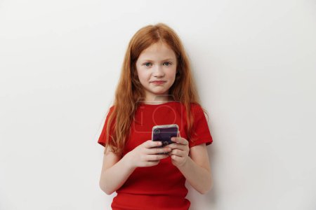 Photo for Phone cute childhood smart small youth technology pretty female beautiful young children person caucasian little smartphone lifestyle mobile kid girl - Royalty Free Image