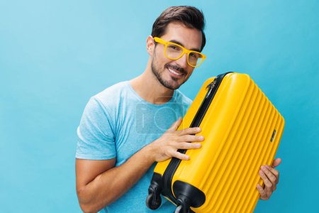 Photo for Man yellow style happy voyage hipster flight suitcase blue background copy trip holiday traveler lifestyle vacation baggage tour space weekend guy ticket luggage travel studio journey - Royalty Free Image