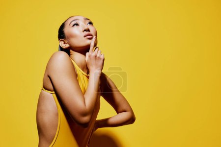 Photo for Model woman joy cute swimsuit lady excited eyes lips smile female skin surprised beauty fashion pretty yellow summer portrait trendy stylish brunette shocked hair - Royalty Free Image
