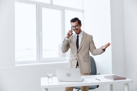 Photo for Man communication call cellphone lifestyle suit laptop call corporate mobile computer businessman office phone winner smile successful talk video modern - Royalty Free Image