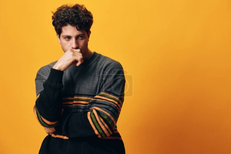 Photo for Trendy man face yellow student happy lifestyle head cool sweater smile model serious casual white handsome caucasian fashion posing standing portrait orange style background - Royalty Free Image