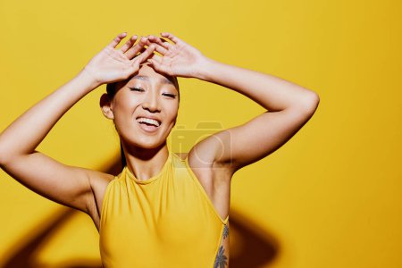 Photo for Mouth woman surprised cheerful beauty portrait skin closeup pretty young asian studio trendy style casual yellow summer emotion smile model fashion swimsuit - Royalty Free Image