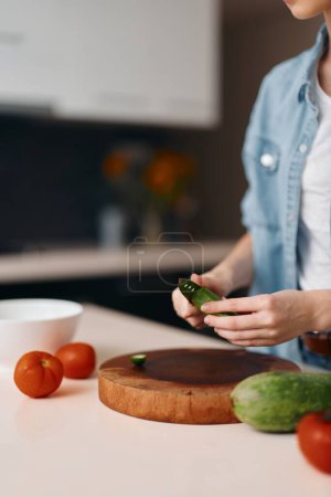 Photo for A Fresh and Healthy Vegetarian Meal: Woman Chef Preparing a Delicious Organic Salad in a Kitchen - Royalty Free Image