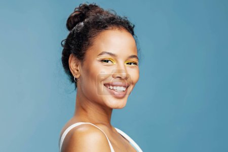 Photo for Skin woman blue shot happy happiness skin close-up smile beauty make-up hair fashion american beautiful studio face woman portrait african curly care studio lifestyle - Royalty Free Image