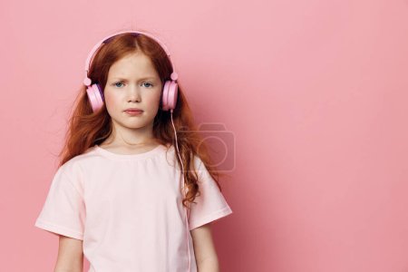 Photo for Headphone child background face person caucasian earphones childhood audio fashion pretty listen music small young cute girl kid beauty portrait adorable female sound little - Royalty Free Image
