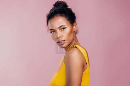 Photo for Model woman cosmetology space pink beauty fashion skin style smile make-up portrait studio cosmetic yellow african creative ethnic eye beautiful face copy colourful black - Royalty Free Image