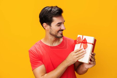 Photo for Sale man model gift studio party copy birthday holiday surprise happy male guy celebration space give present celebrate christmas valentine gift holding box box - Royalty Free Image