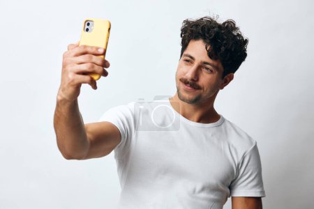 Photo for Man travel using happy technology guy online white young beard male phone message adult mobile hipster model portrait businessman face t-shirt attractive expression lifestyle - Royalty Free Image