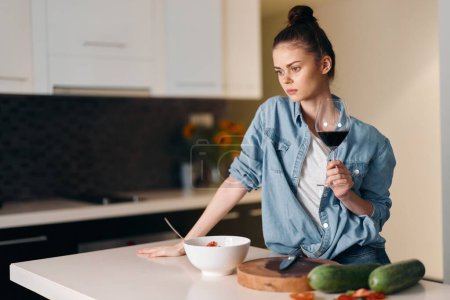 Photo for Attractive Caucasian Woman Cooking a Healthy Breakfast in a White Kitchen, Standing at the Table with Fresh Organic Vegetables and a Pan, Portrait of a Pretty Housewife Enjoying Her Delicious Meal - Royalty Free Image