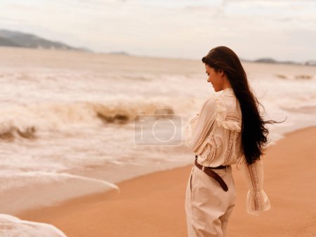 Photo for Carefree Beauty: A Young Caucasian Woman Walking Alone on a Sunny Beach, Embracing the Summer Vibes and Enjoying the Relaxing Freedom of Nature. - Royalty Free Image