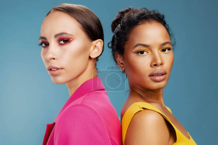 Photo for Attractive woman american eye girl colorful healthy face together care make-up shine caucasian studio beauty model happy two mixed african beautiful skin portrait yellow bodycare race - Royalty Free Image