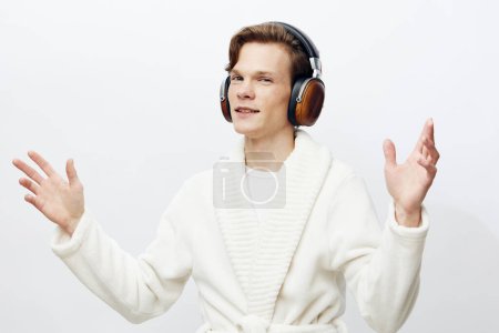 Photo for Modern Man Grooving to the Beat: A Stylish Caucasian Guy, Rocking Red Headphones and Expressing himself through Music - Royalty Free Image