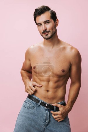 Photo for Man body muscular sexy shirtless pink jeans sport fitness torso muscle bicep lifestyle fashion belt background beauty model holiday naked - Royalty Free Image