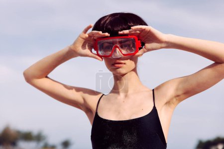 Photo for Smiling Woman in Red Fashion Swimsuit, Snorkeling Mask, and Snorkel on Tropical Beach Vacation - Royalty Free Image