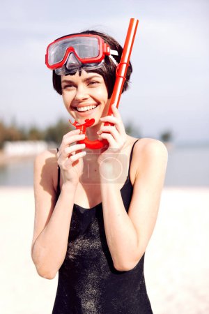 Photo for Red-Fashioned Fun: Smiling Woman Snorkeling in a Tropical Paradise - Royalty Free Image