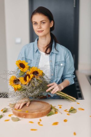 Photo for Floral Portrait: Young Caucasian Woman, Attractive and Happy, Holding a Fresh Bouquet, in Modern Kitchen. - Royalty Free Image