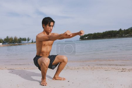 Photo for Muscular Asian Athlete Enjoying Beachside Cardio Workout at Sunset - Royalty Free Image
