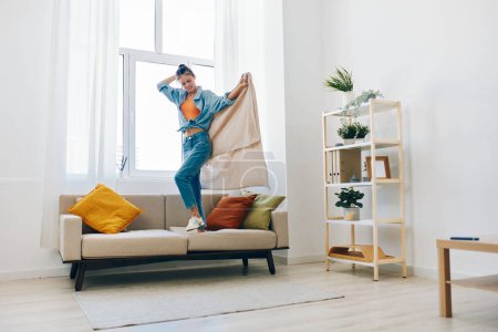 Foto de The Joyful Home Jumper: Una mujer juguetona bailando y cantando con felicidad en un relajante apartamento interior - Imagen libre de derechos