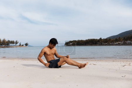 Photo for Active Asian Man Running on Beach, Exuding Strength and Freedom in Outdoor Fitness Training - Royalty Free Image