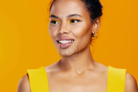 Photo for Model woman beauty studio space colourful cosmetic face yellow fashion black skin smile beautiful make-up creative cosmetology african copy style portrait - Royalty Free Image