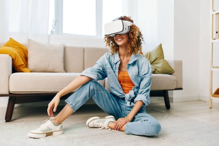 Photo for Smiling Woman Enjoying Virtual Reality Game at Home with Futuristic VR Glasses - Royalty Free Image