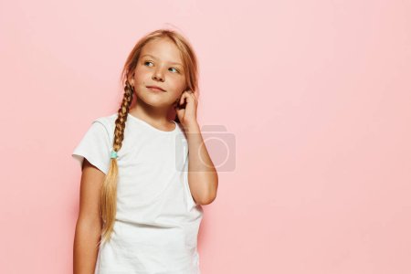 Photo for Charming Little Schoolgirl with Stylish Pink Fashion and Bright Yellow Background - Royalty Free Image