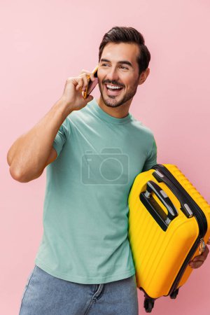 Photo for Man baggage white luggage tour studio journey smile tourist tourism guy adult suitcase hotel traveler airport trip travel passenger smartphone phone vacation mobile service - Royalty Free Image