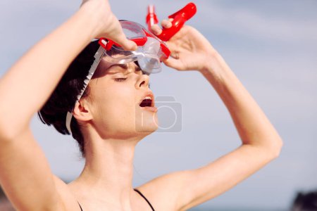 Photo for Smiling Woman in Red Snorkeling Mask: Fashionable Swimsuit and Tropical Fun at the Beach - Royalty Free Image