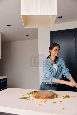Foto de Limpio y atractivo: Una mujer joven bastante caucásica cocinando una comida saludable en una cocina moderna - Imagen libre de derechos