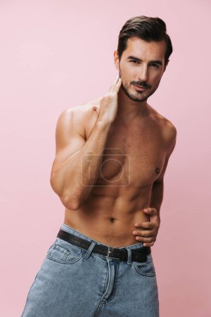 Photo for Muscular man jeans background fashion torso bodybuilder naked lifestyle belt sexy fit muscle model bicep sport pink body holiday beauty shirtless strong fitness - Royalty Free Image
