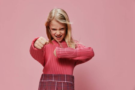 Photo for Happy Schoolgirl with Stylish Pink Background and Joyful Expression - Royalty Free Image
