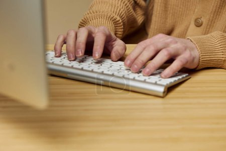 Photo for Tech-savvy Man Typing on Laptop Keyboard in a Modern Office Setting - Royalty Free Image