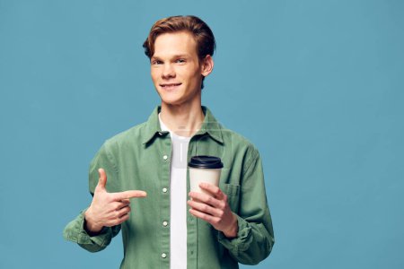 Photo for Coffee Cravings: Handsome Caucasian Guy Enjoying a Hot Beverage with a Smile - Royalty Free Image