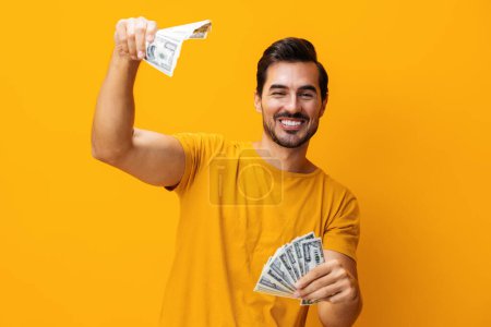 Photo for Excited man casino currency business background wealth smiling cash happy credit dollar yellow money studio surprised success finance hand shopping rich - Royalty Free Image