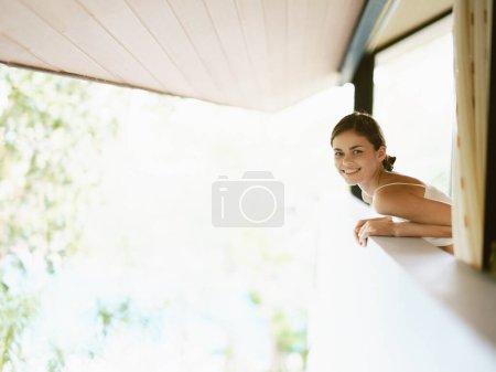 Photo for Tropical Summer Retreat Woman Smiling on the Balcony of a Trendy Apartment, Enjoying a Relaxing Vacation in a Sunlit Paradise - Royalty Free Image