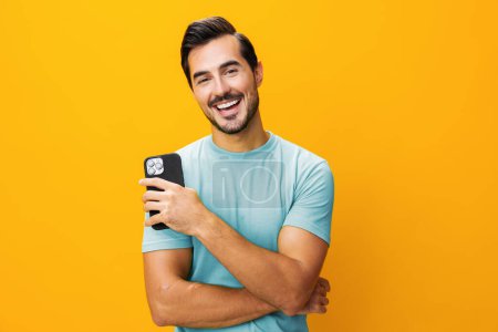 Photo for Mobile man space smiling message technology happy pointing cyberspace portrait surprise phone copy communication smartphone lifestyle yellow business studio eyeglass phone - Royalty Free Image